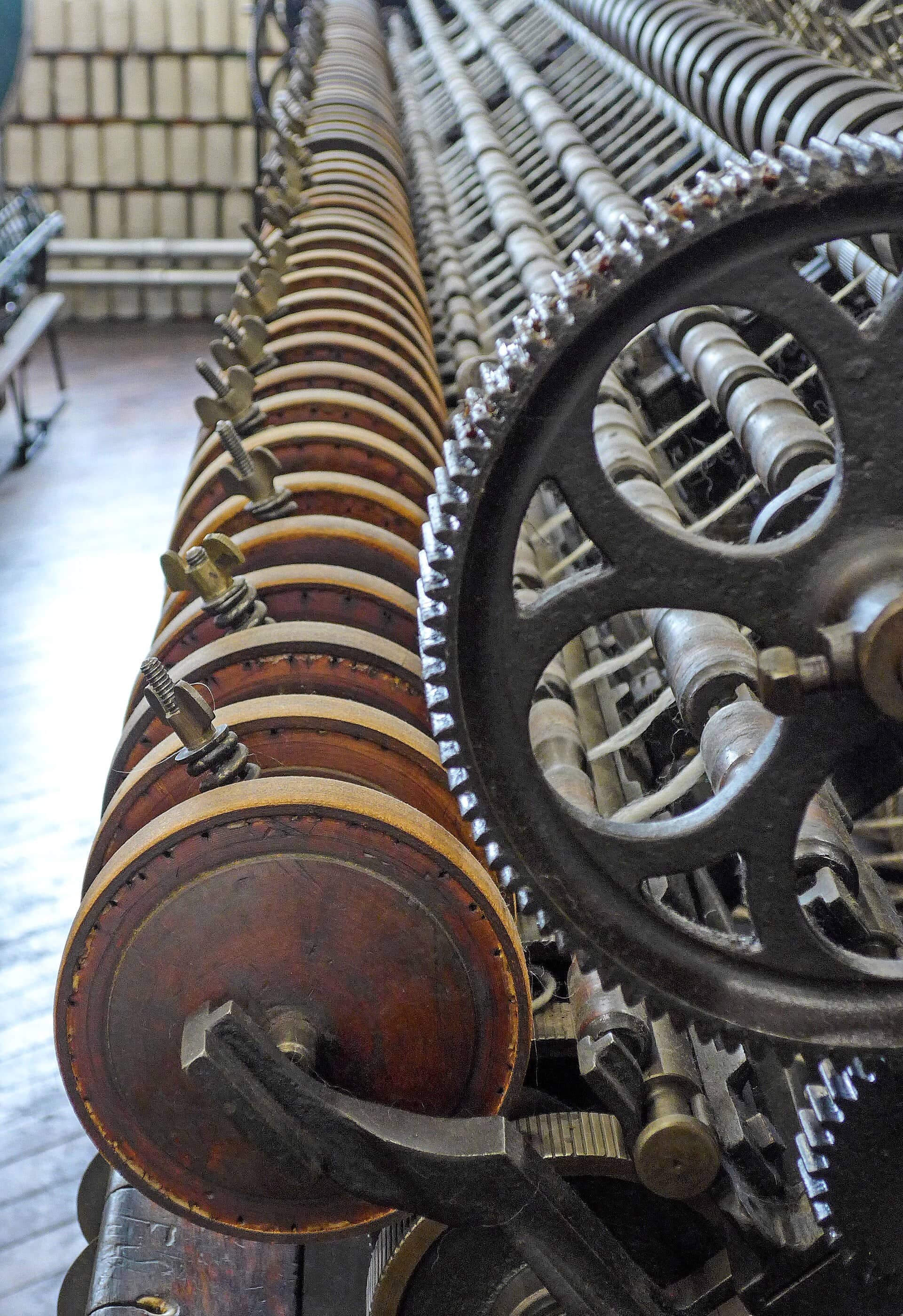 Close-up of textile machinery gears and bobbins