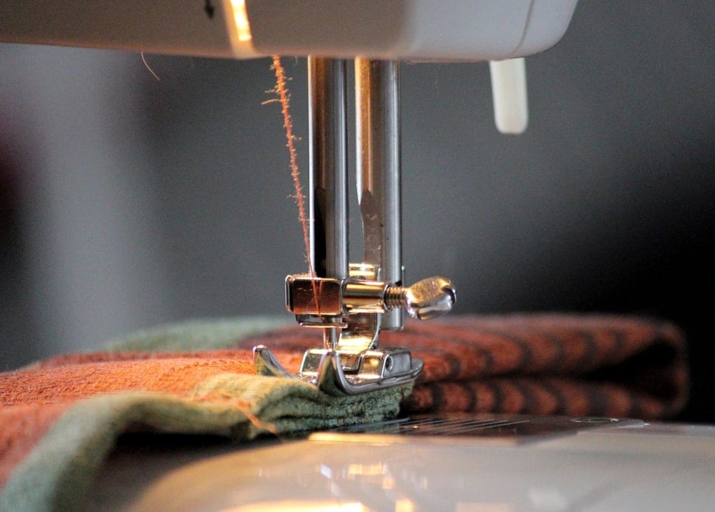 Sewing machine presser foot stitching patterned fabric
