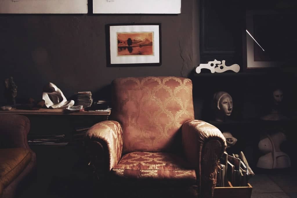 Upholstered armchair in a dimly lit room