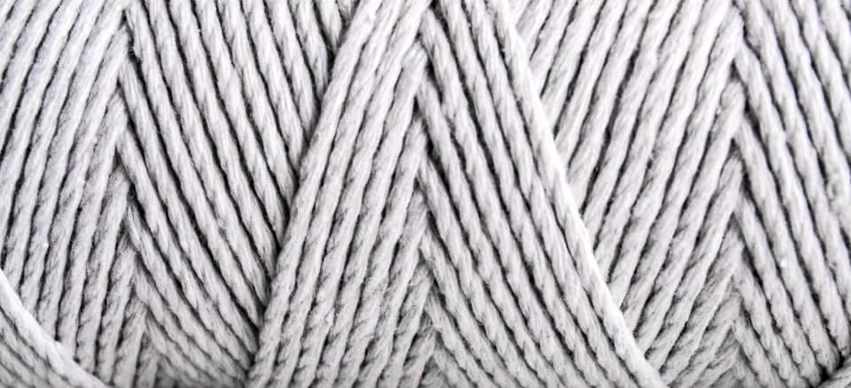 Macro view of twisted white yarn plies
