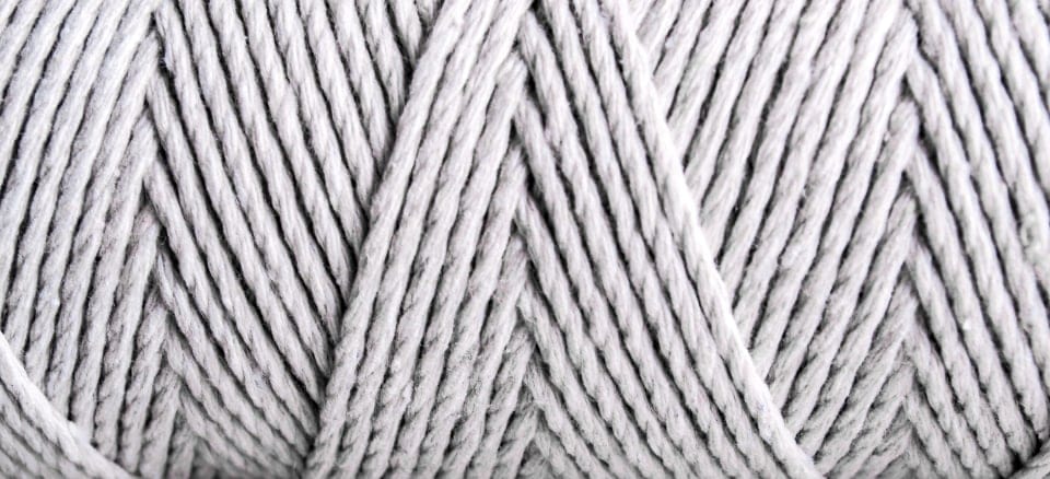Macro view of twisted white yarn plies